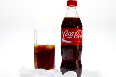Coca Cola  with glass and ice on white background