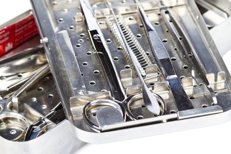 surgical instruments in a steel casing isolated on whiteの写真素材