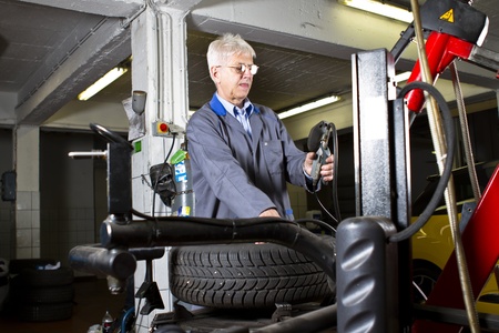 Tire change technician in the repair shopの写真素材