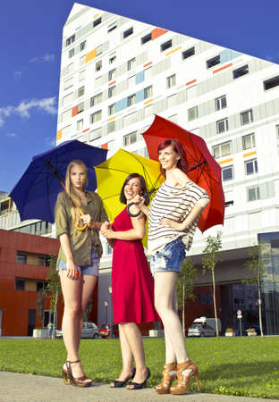 Girls with umbrellas in urban areaの写真素材