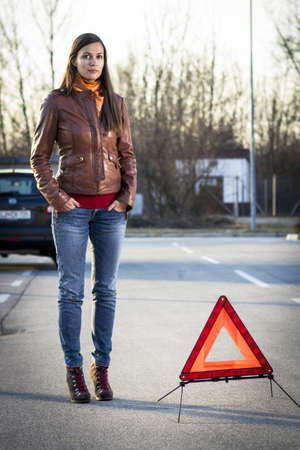Woman with broken car seeking helpの写真素材
