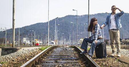 Young couple waiting for the train in lost stationの写真素材