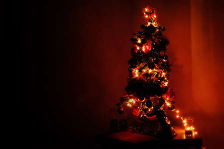 Christmas tree with red shades and lights, chirimbolos and pineconesの写真素材