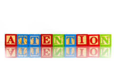 attention word reflection on white backgroundの写真素材