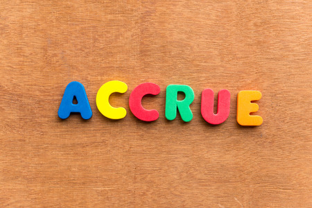 accrue colorful word on the wooden backgroundの写真素材