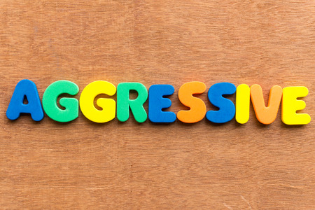 aggressive colorful word on the wooden backgroundの写真素材