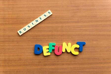 defunct colorful word on the wooden backgroundの写真素材