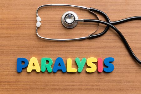 paralysis colorful word on the wooden backgroundの写真素材