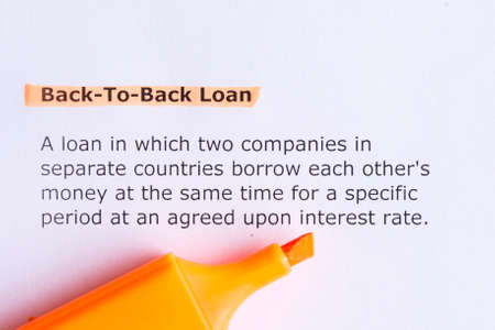 back to back loan   word highlighted  on the white paperの写真素材