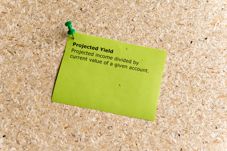 projected yield word typed on a paper and pinned to a cork notice boardの写真素材