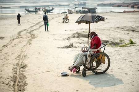 Kushtia, Bangladesh - February 22, 2014: A begger is begging on a  street at Kushtia, Bangladesh.のeditorial素材