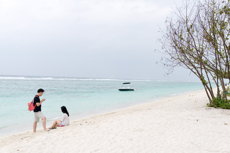 Male, Maldives - February 18, 2016: Couple on a beach jetty at Maldivesのeditorial素材