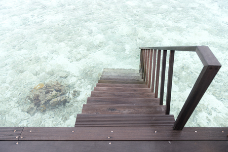 clean timber stair into the clear water surface.の写真素材