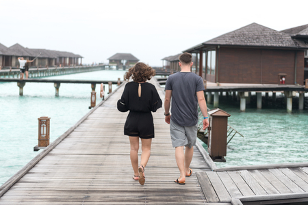 Male, Maldives - February 18, 2016: Couple on a beach jetty at Maldivesのeditorial素材