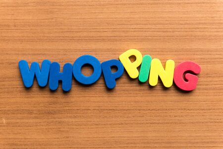 whopping colorful word on the wooden backgroundの写真素材