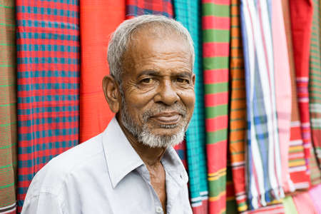 Kushtia, Bangladesh - May 19, 2016: sales person is selling colorful towels on supermarket at kushtia, bangladeshのeditorial素材