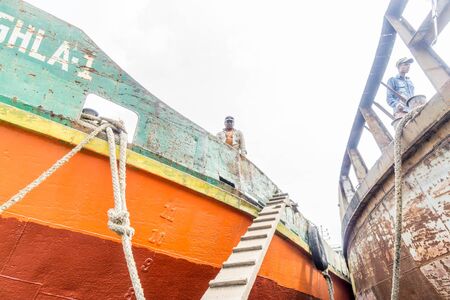 DHAKA, BANGLADESH - August 12: Local workers are working to repair ships in dockyard on August, 12, 2016 in Dhaka, Bangladeshのeditorial素材