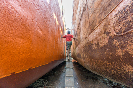 DHAKA, BANGLADESH - August 12: Local workers are working to repair ships in dockyard on August, 12, 2016 in Dhaka, Bangladeshのeditorial素材