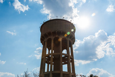 Center screen view of the Northcliff Reservoir with Clouds behind the water tower and antennas on topの写真素材