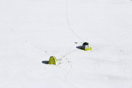 Tents on the frozen river with many traces. From the height of bird flight.の写真素材