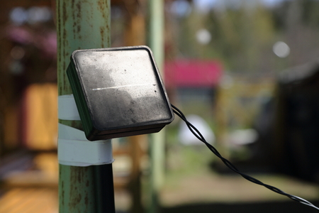 The old solar panel for lighting on the pole.の写真素材