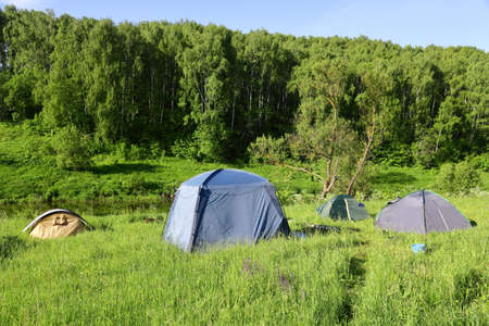 Tents on the river Bank on a Sunny morning.の写真素材