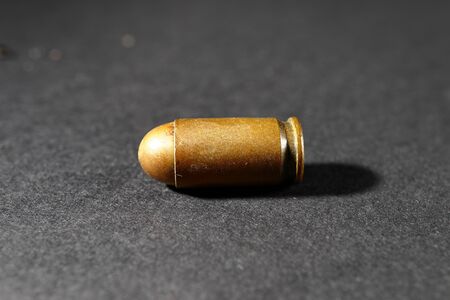 Bullet from a gun on a black background.の写真素材