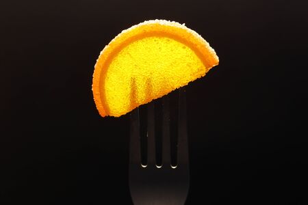 Sweet dessert. Slices of marmalade and jelly beans on a fork.