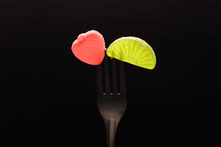 Sweet dessert. Slices of marmalade and jelly beans on a fork.の写真素材
