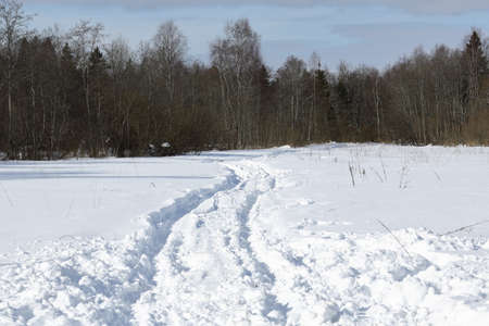 Road on which there are ruts from cars on the roadway.