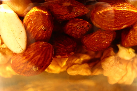 Glass jar with different nuts in honey.の写真素材