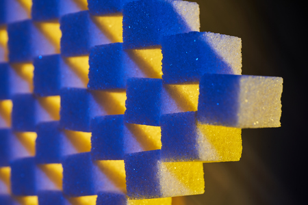 A composition of sugar cubes illuminated with multicolored light sources.の写真素材
