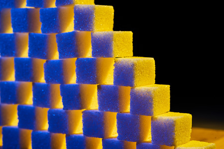 A composition of sugar cubes illuminated with multicolored light sources.の写真素材