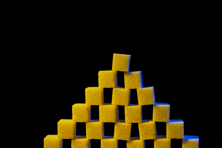 A composition of sugar cubes illuminated with multicolored light sources.の写真素材