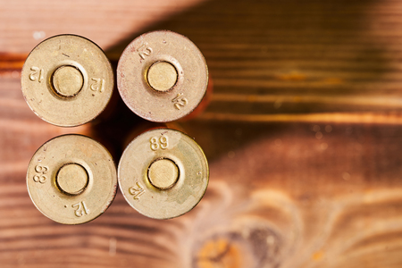 Hunting shells and 12 gauge cartridges on wooden background.の写真素材