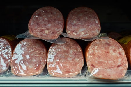 Sausages in packing on a shop window.