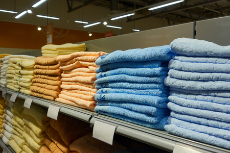Stacks of folded towels on the shelf in the store.の写真素材