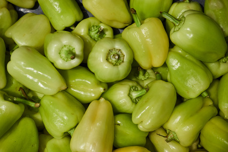 Green bell peppers on the shop window.の写真素材