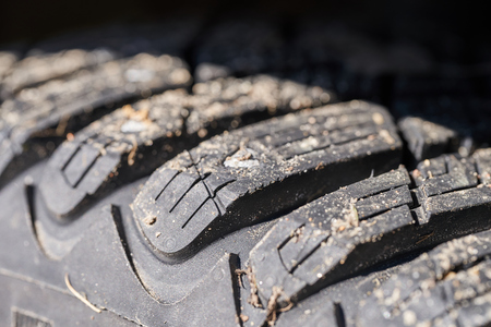 Car tire tread with spikes close up.