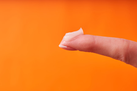 Beautiful manicured girl hands with moisturizing cream.の写真素材