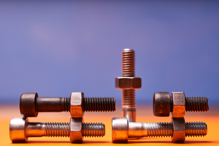 Bolted connecting elements on orange, blue background close-up.の写真素材