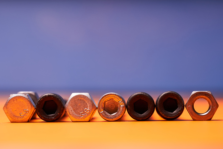 Bolted connecting elements on orange, blue background close-up.の写真素材