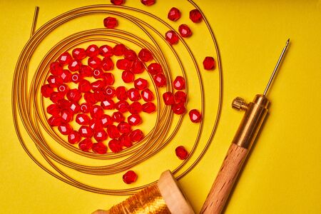Embroidery products and tools. Luneville hook and red roundels on a yellow background.の写真素材