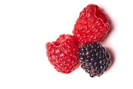 Raspberries and blackberries isolated on white background.の写真素材