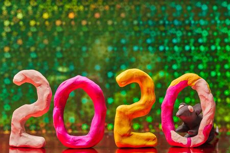 2020 New year design concept with the symbol of the year rat. Colored figures of plasticine on a green background.の写真素材