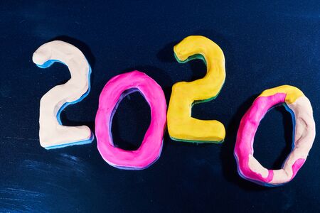 2020 New year design concept. Colored figures from plasticine on a blue background.の写真素材