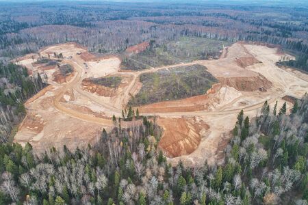 Aerial view with a drone. Landscape with autumn forest and sand quarry.