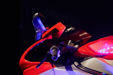Sportbike on a black background. Front part. Mixed lighting.