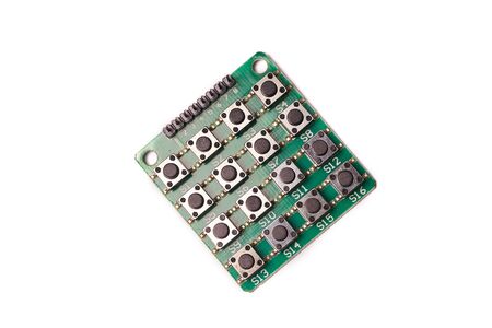 Lots of black little buttons on green PCB isolated on white background.
