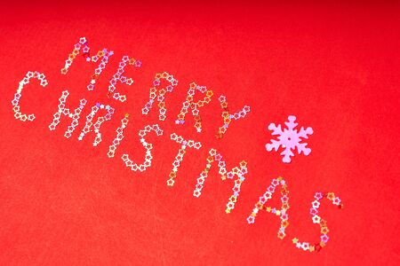 Inscription merry Christmas of decorative stars on a red background.の写真素材